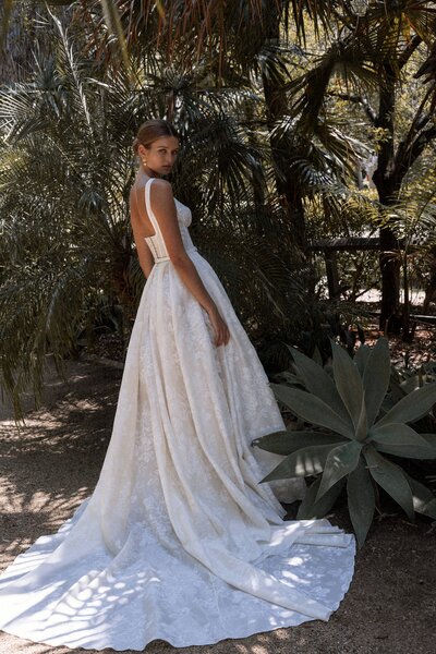 black and white image bride wearing  long sleeve lace wedding dress