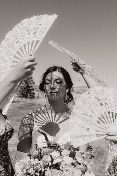 Eclectic bride gets fanned by her bridesmaids in Drumheller, Alberta