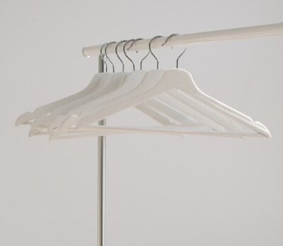 White hangers hanging on a small pole