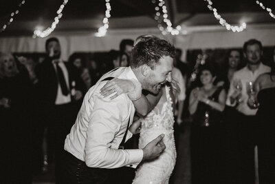 Bride and groom laughing during wedding reception dancing, a lively celebration captured in Breckenridge.