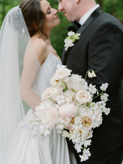 bride holding a white and pink flower bouquet