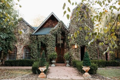 The bride to be sits between her fiancé's legs while he wraps his arms around her and they share a loving glance