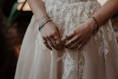 detail shot of bride's jewelry and dress