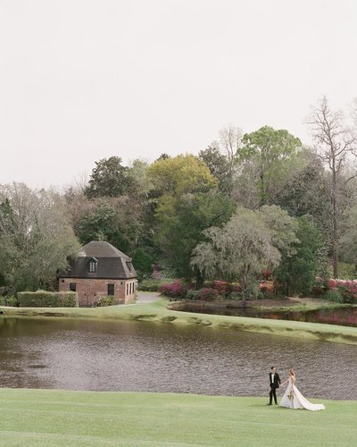 Bird's eye view couple portrait with a manicured landscape and tranquil marsh views