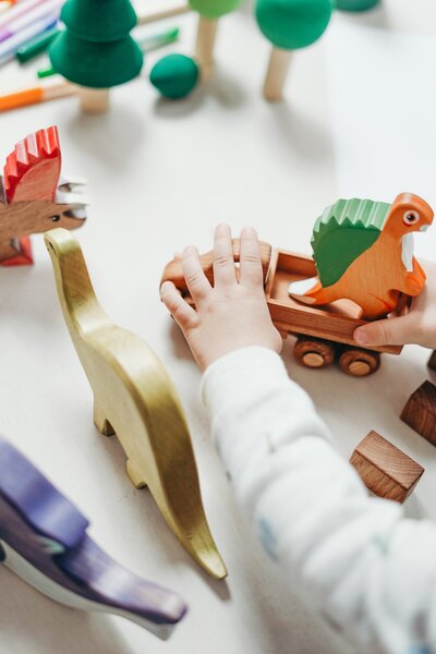 little hand playing with dinosaur  toys