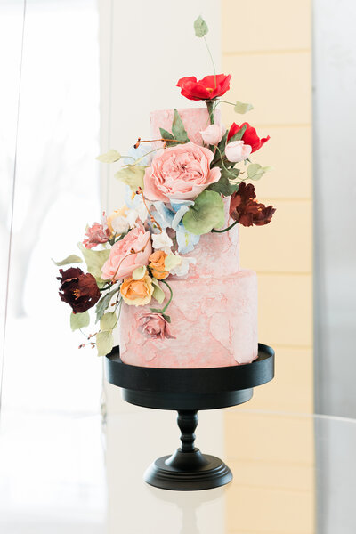 floral decorated pink wedding cake by michelle mayer