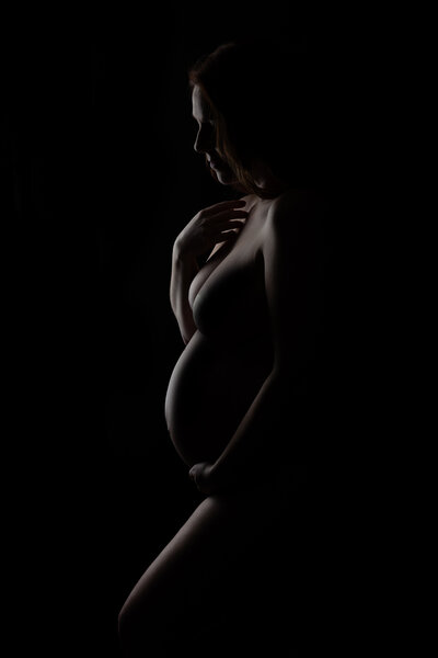 Black and white silhouette of pregnant mother.
