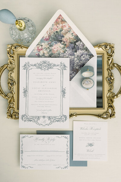Victorian-inspired wedding invitation in dusty blue featuring regal design elements and an impressionism envelope liner, offering elegant invitation ideas for a sophisticated celebration.