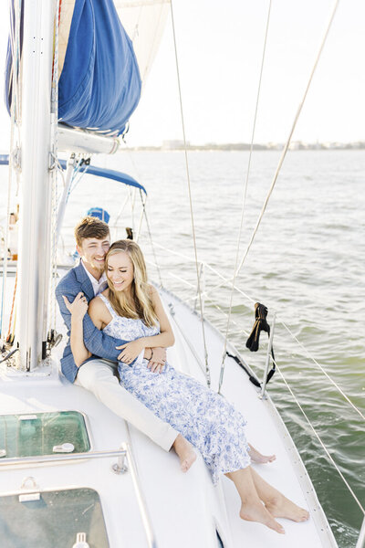 laura and her fiance embracing on a sailboat