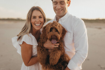 Engaged Couple with dog at beach in NH