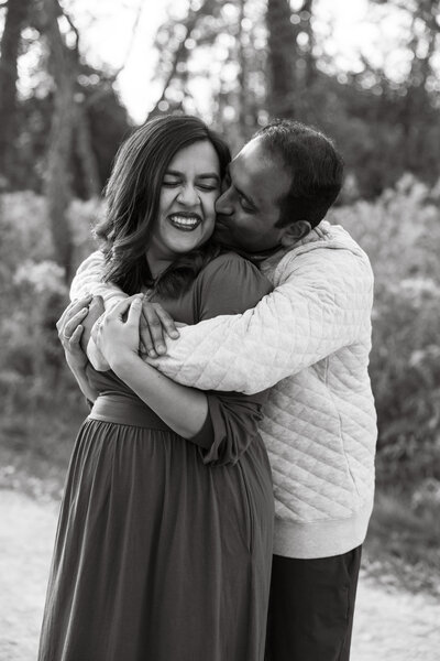 Husband holding pregnant wife from behind during maternity session by Taylor Lynn Studios