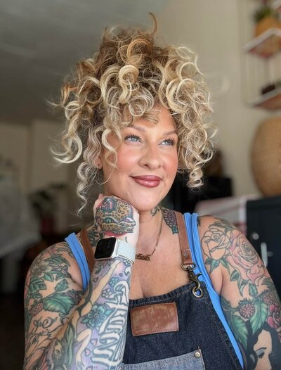 Libby a licensed esthetician smiles at the camera.