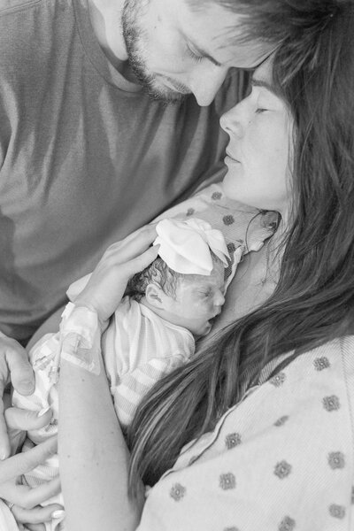 grieving parents holding their baby