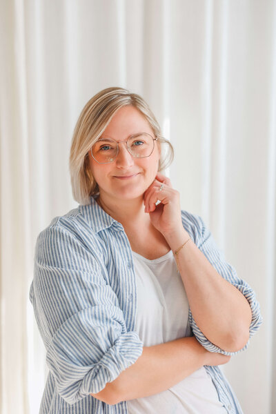 Woman wearing striped button down posing for headshot