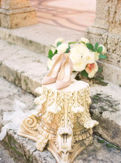 detail shot of bride's wedding shoes and her flower bouquet at Vizcaya Museum wedding photographer