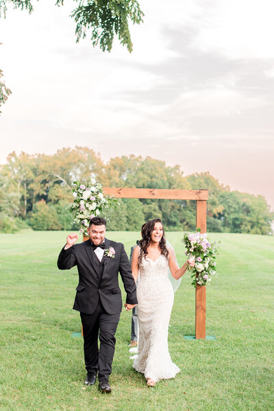 couple celebrating walking out of the aisle