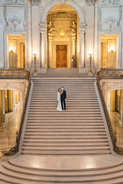 Captivating image of a bride gracing the balcony of San Francisco City Hall, offering a blend of architectural grandeur and bridal beauty.