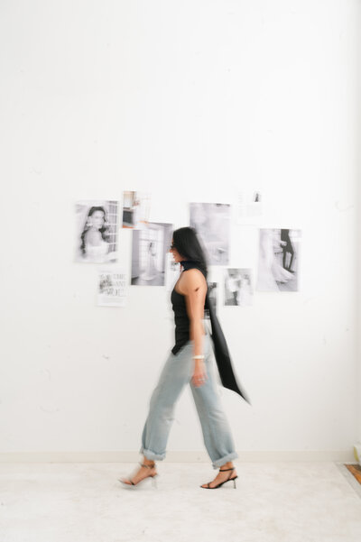 Newport RI Wedding Photographer | Rhode Island Caprio Captured Photography | Alicia Caprio Walking In A Studio In Jeans And Black Top