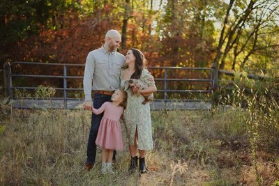 Candid photo of a man, woman, and little girl.