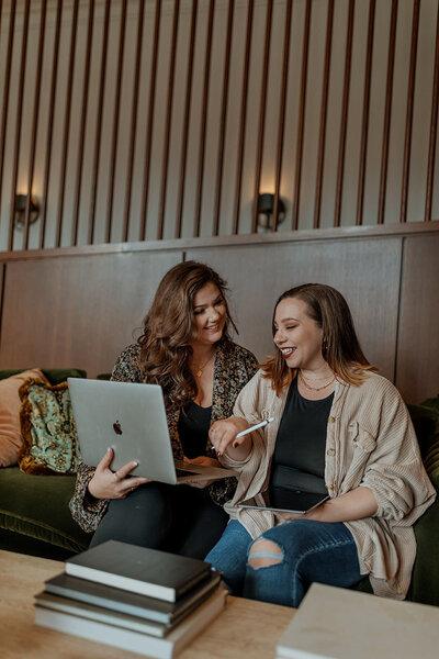 women sitting on couch