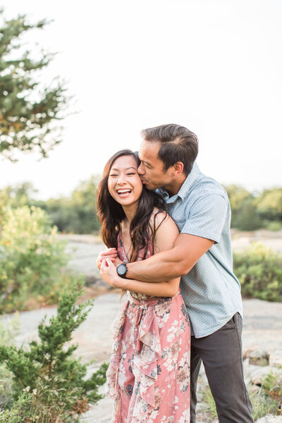 couple touching foreheads in Arnold Arboretum