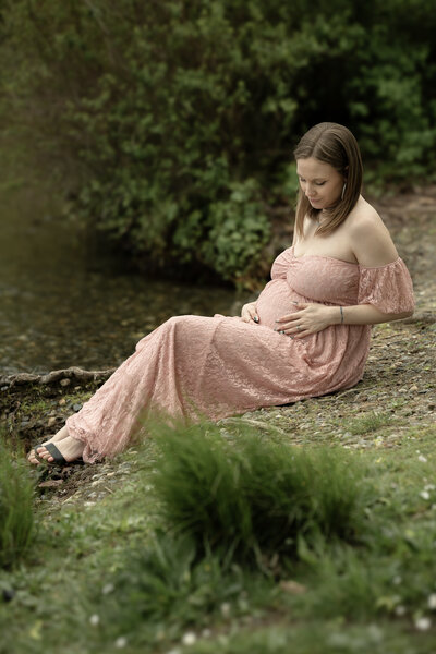 Seattle maternity photographer with Thistle and Bloom Photography captures special moment during Maternity session in the park.