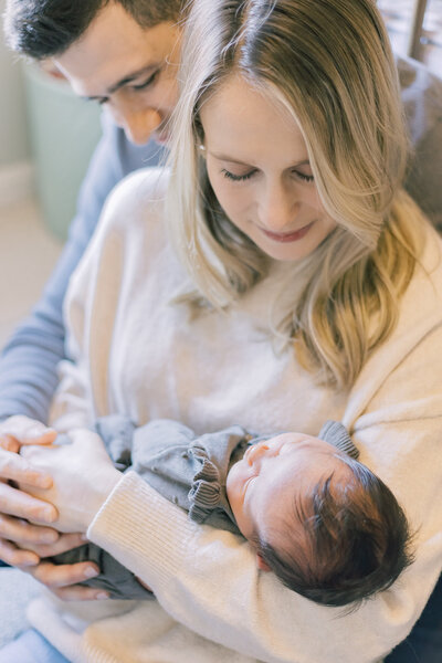 Close up of couple holding their newborn during family portrait session