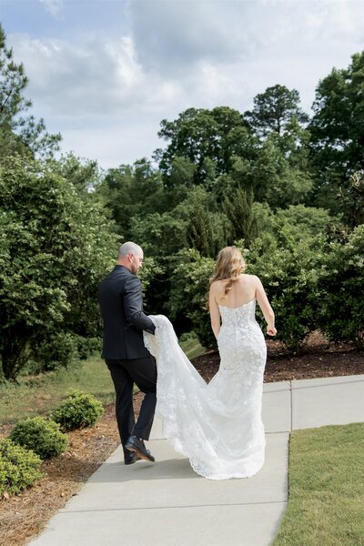 Bride walking with her father toward the ceremony at a Raleigh, North Carolina wedding, captured in photo and video by Moments by Hiba.