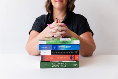 A stack of textbooks used to help therapy clients in Canon City