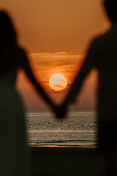 Couple eloping on a beach in France at sunset