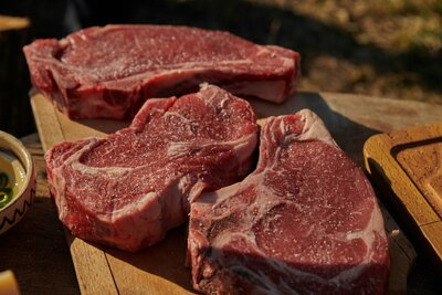 Three fresh cut rib-eye steaks
