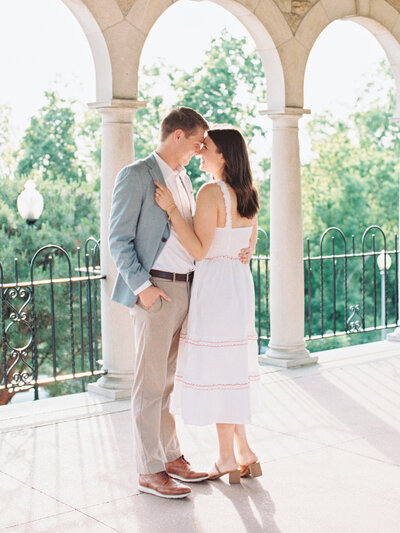 Bride and groom nose to nose under arches during engagement photos at Alms Park in Cincinnati, Ohio