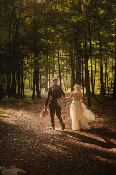 Just eloped - a couple hiking through the Adirondacks after their elopement.