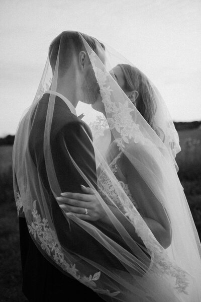 bride and groom kidding under veil
