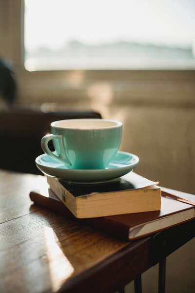 Cut of coffee stacked on top of two books