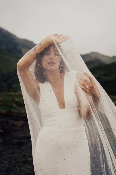 bride poses behind her veil in charlotte wedding