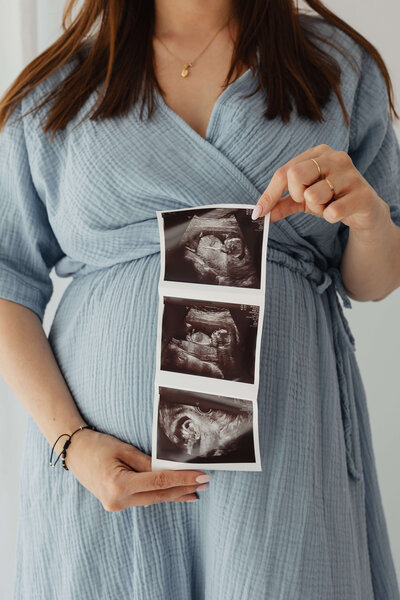 expecting mom holding an ultrasound photo