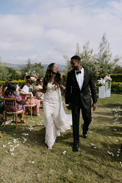 Keiyana and Chase walk down the aisle with excitement after just saying "I do." 