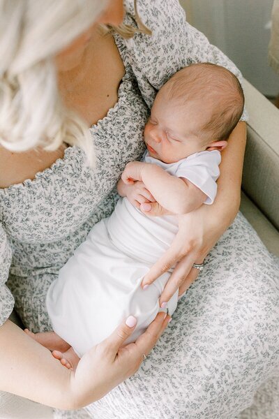 Katelyn Ng Photography, an Indianapolis Photographer, photographed  a mother holding her newborn son.