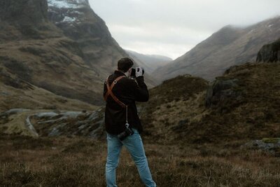 Scotland elopement photographer taking images of his bride and groom during a golden hour elopement in Glencoe, Scotland