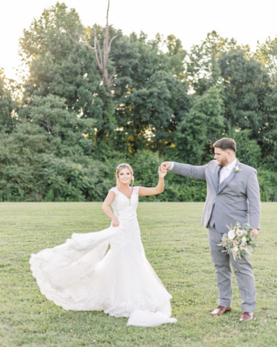 Photo of bride and groom dancing outside