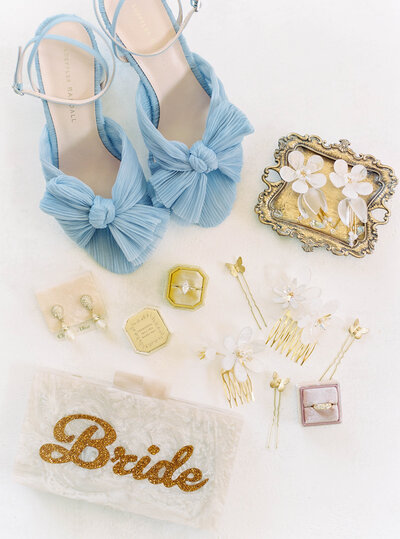 Wedding detail flatlays with blue shoes and jewelry at wedding planned by Bianca Nichole and Co