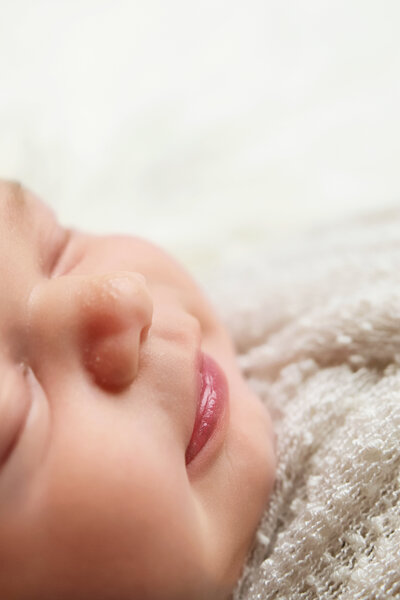 Newborn baby profile with a smile