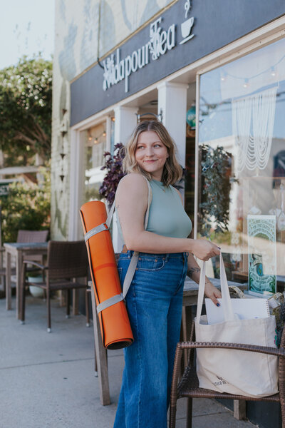 yoga-teacher-with-orange-mat-for-brand-session-state-street-greensboro-nc
