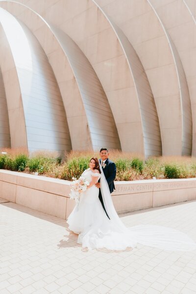 Bride and groom posing in front of the st louis mo veteran's memorial