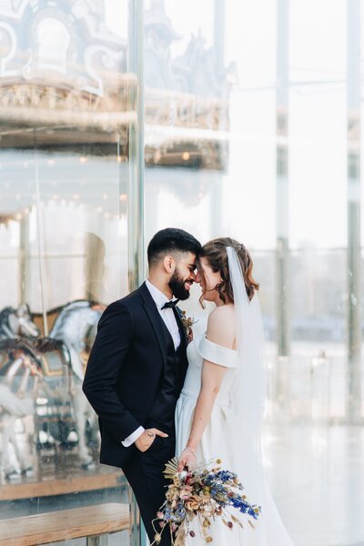 bride and groom smiling at one another