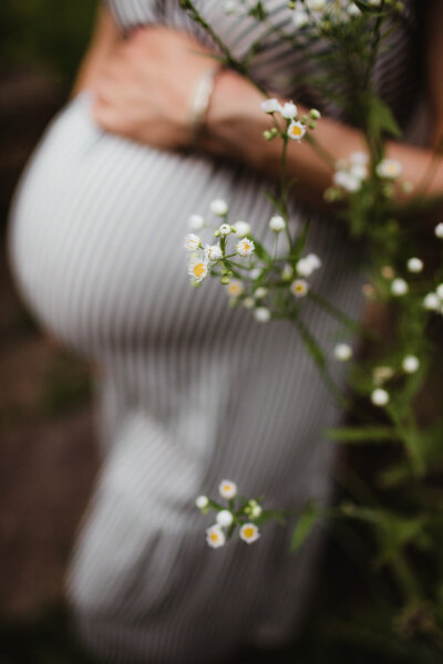 A pregnant mother cradles her growing belly during her maternity session in Madison WI.