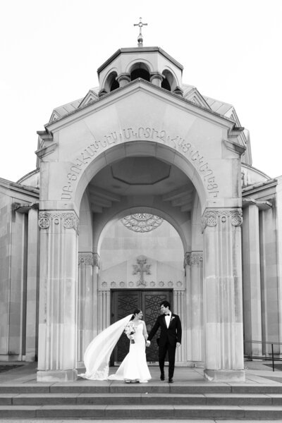 bride and groom walking up stairs