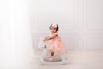 Baby girl on a rocking horse