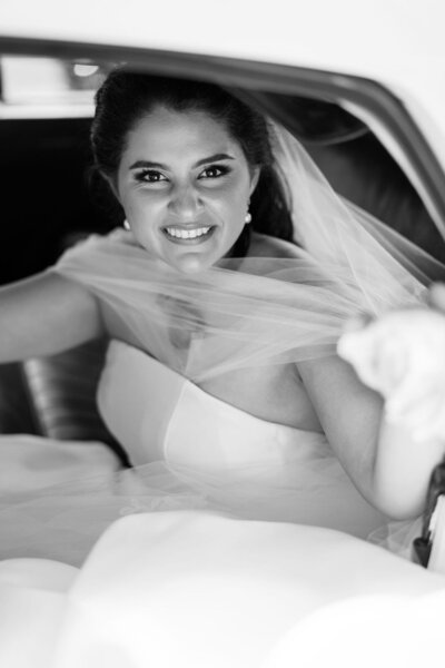 bride smiling in classic car